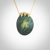A lovely disc design with cupping on one side and the lightly convex form on the other - a little feature that captures the light and gives the piece a sense of movement and form. Hand made from New Zealand Jade by Ric Moor. Delivered with an adjustable beige cord.